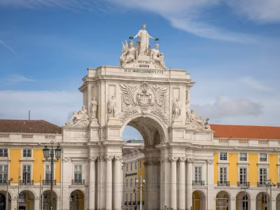 Historic white clock-tower building in Lisbon's Baixa district
